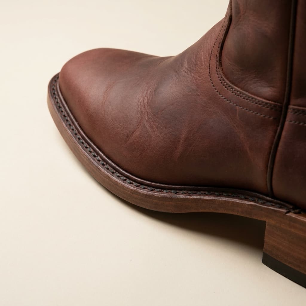 Hand-welt and sole-edge detail of The Saguaro: hand-welted leather sole, double-row stitch, pull-up bovine in oxblood, oil-finished