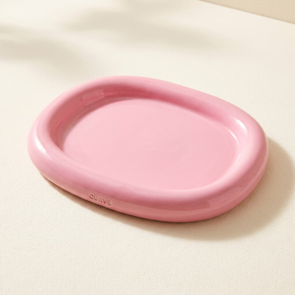 Curve Cloud Tray, a chunky stoneware serving tray with rounded corners in candy pink.