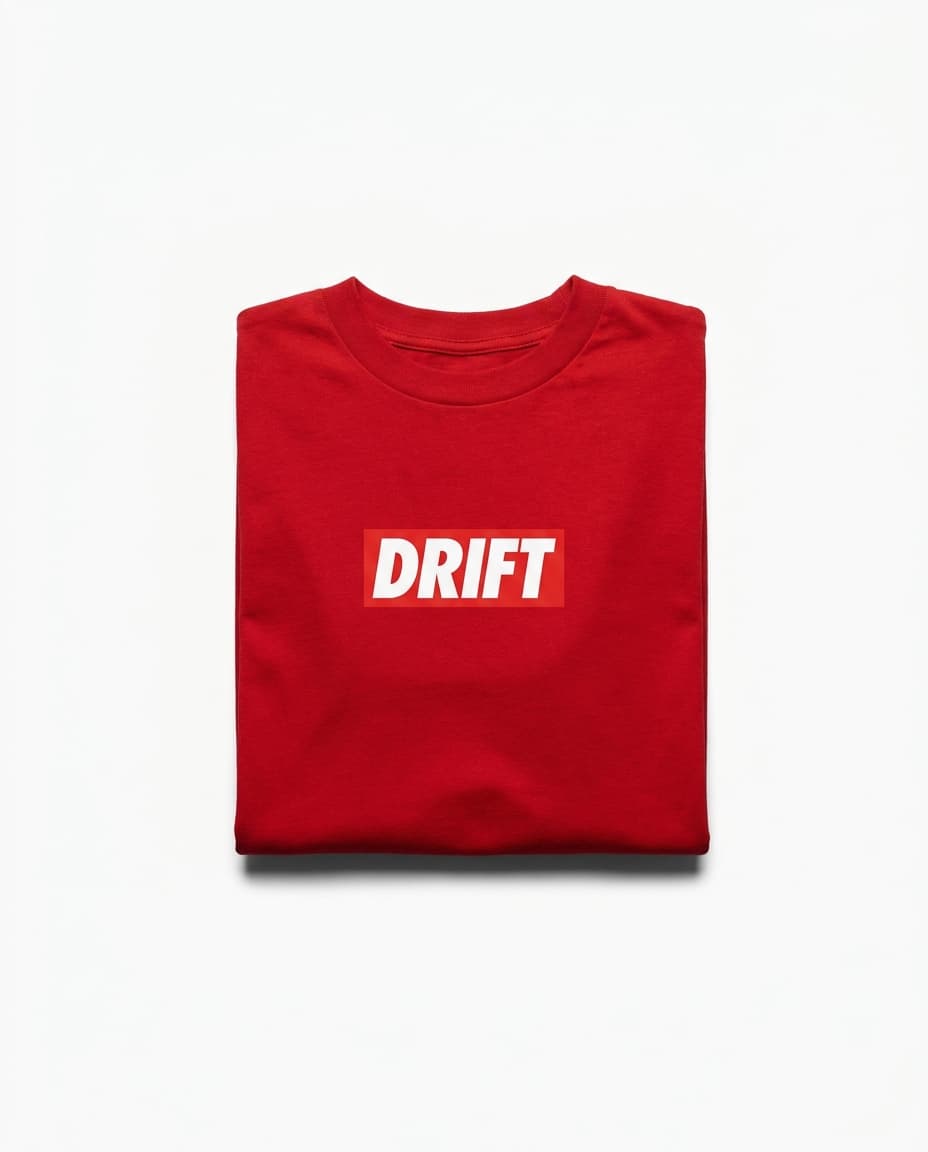 Drift hero: a folded red heavyweight cotton t-shirt on a stark white background.
