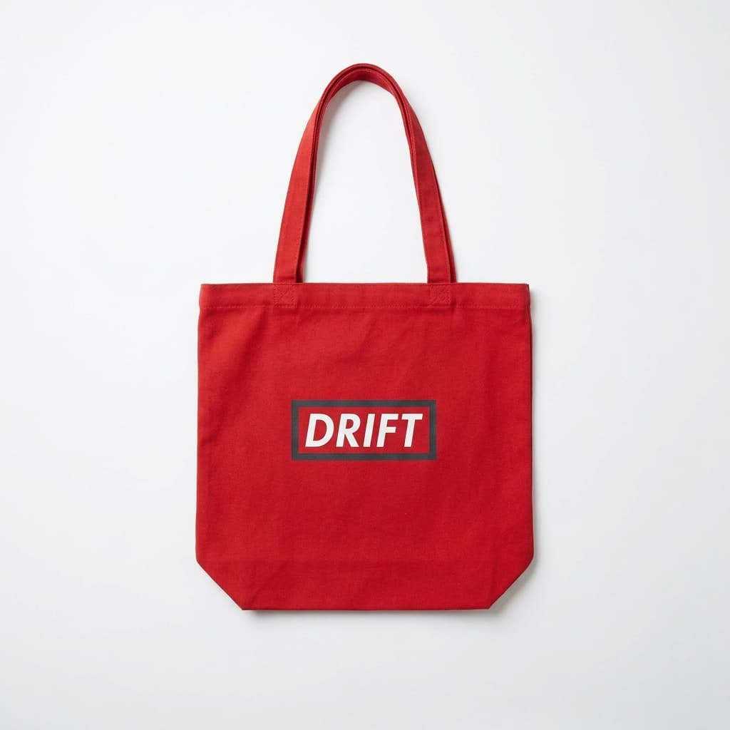 Drift red tote with white box logo, on stark white.